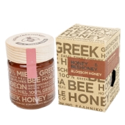  Premium Greek Raw Blossom Honey presented with wildflowers, emphasizing its natural and floral origins.